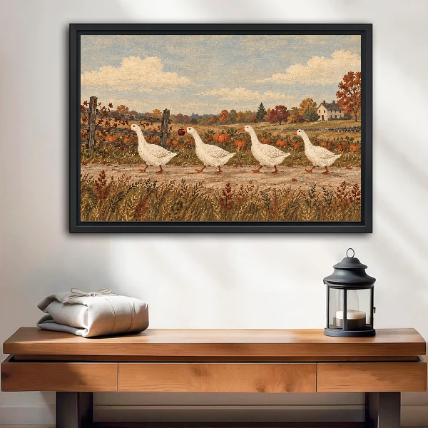 country harvest geese canvas wall art framed above a wooden table with lantern and folded blankets.