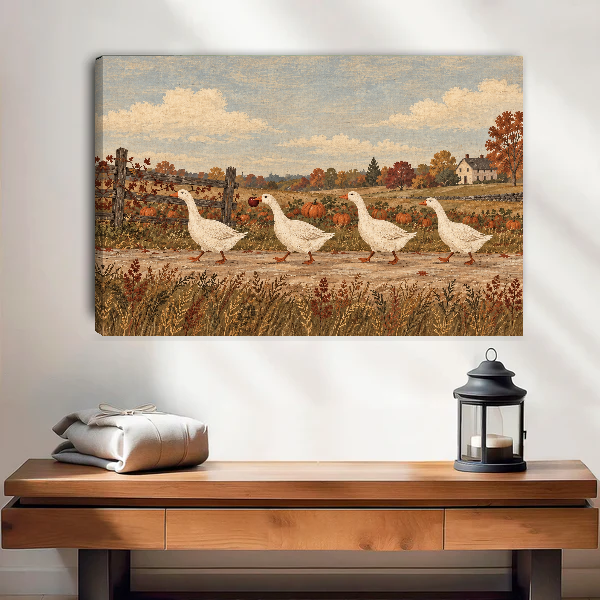country harvest geese canvas wall art unframed above a wooden table with lantern and folded blankets.