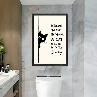Funny Bathroom Cat Canvas Wall Art framed above a toilet beside marble walls and wood door.