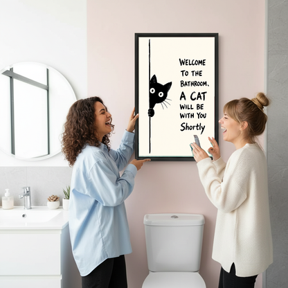 Funny Bathroom Cat Canvas Wall Art held by two women beside a bathroom mirror and toilet.