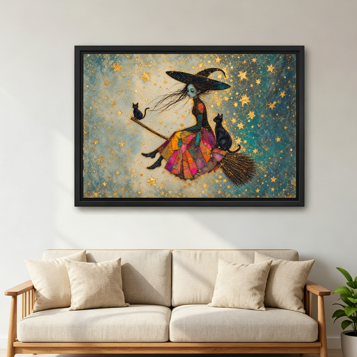 Patchwork Witch and Cats canvas art framed above a cream sofa with wooden arms.