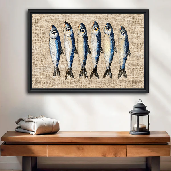 Six Curious Blue Sardines canvas art framed above a wooden table and lantern.