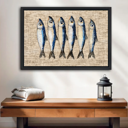 Six Curious Blue Sardines canvas art framed above a wooden table and lantern.