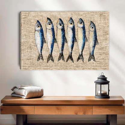 Six Curious Blue Sardines canvas art unframed above a wooden table and lantern.