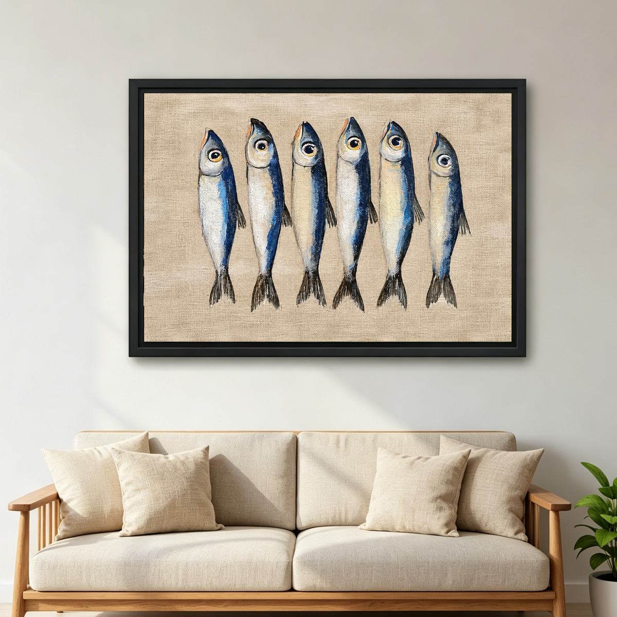 Six Curious Blue Sardines canvas art framed above a cream sofa with wooden arms.