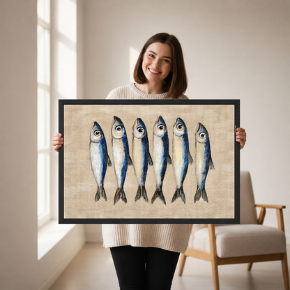 Six Curious Blue Sardines canvas art framed, held by a woman in a neutral room.