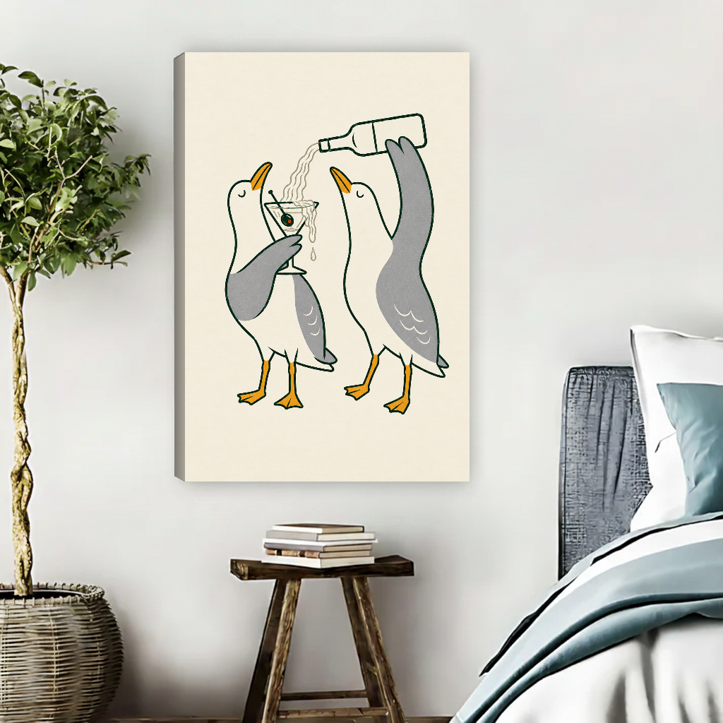 Martini Pouring Seagull Pair canvas art unframed beside muted blue bedding and a potted tree.