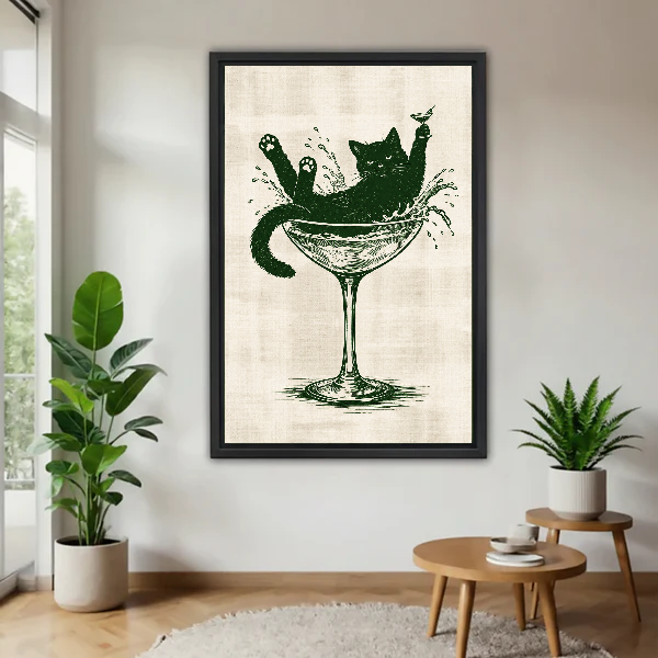 Martini Glass Lounging Cat canvas art framed beside green plants and a round wooden table.