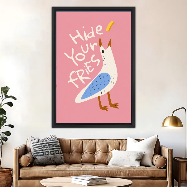 Hide Your Fries Seagull canvas art framed above a brown leather sofa and brass lamp.