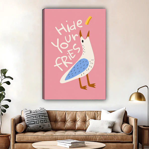 Hide Your Fries Seagull canvas art unframed above a brown leather sofa and brass lamp.