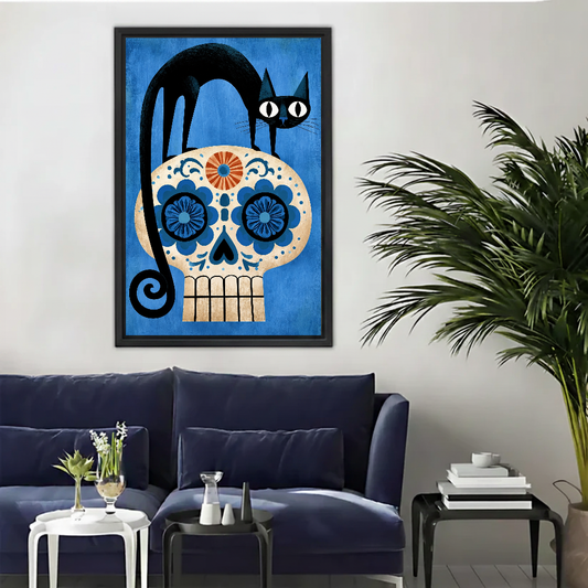 Black Cat Floral Skull canvas art framed above a navy sofa beside a palm.