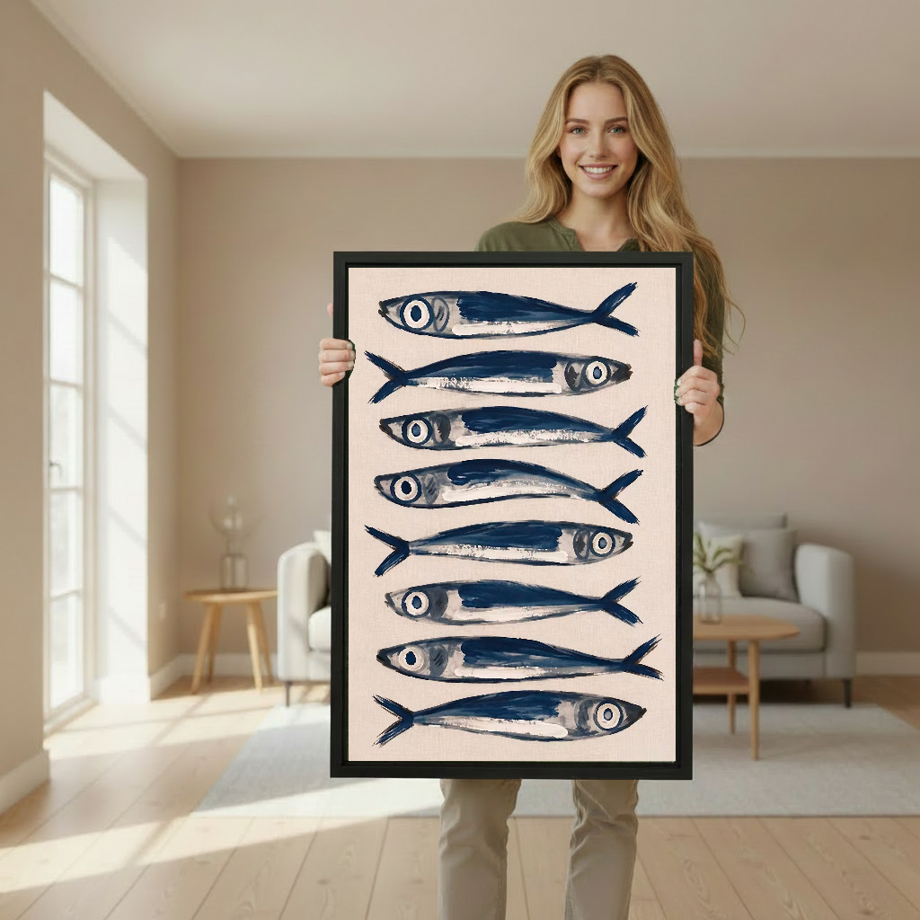 Blue Sardines Canvas Wall Art held by a standing woman in a softly lit room.