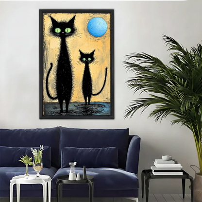 Black Cats Moon Canvas Wall Art framed above a navy sofa beside a leafy palm.