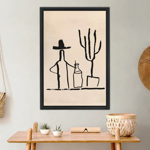 Cowboy Cactus Canvas Wall Art framed above a light wood console with cacti.
