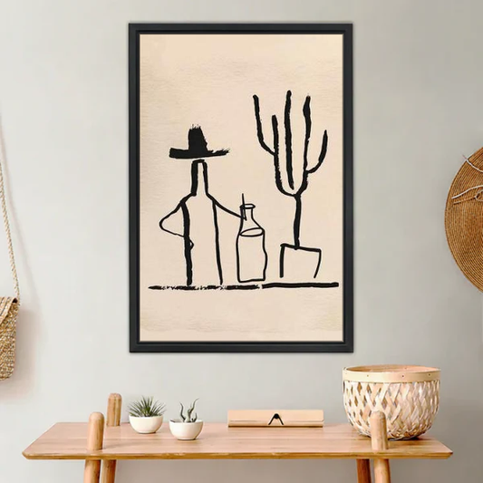 Cowboy Cactus Canvas Wall Art framed above a light wood console with cacti.