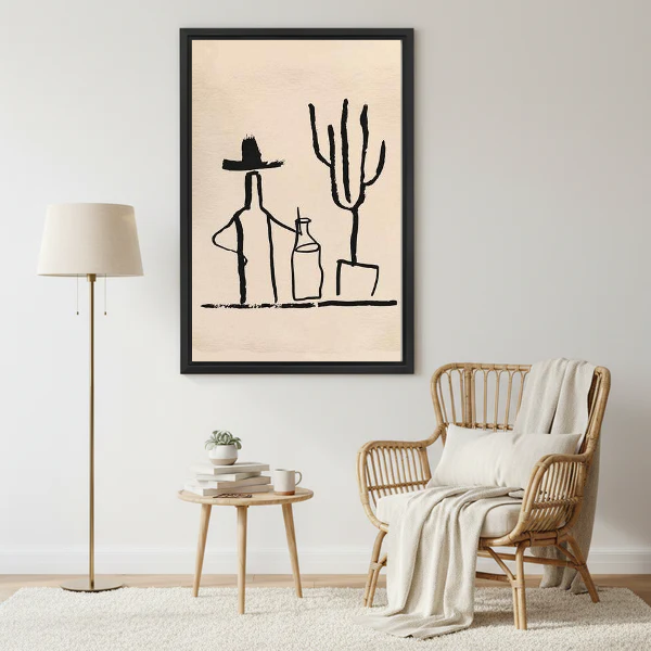 Cowboy Cactus Canvas Wall Art framed beside a wicker armchair with floor lamp.