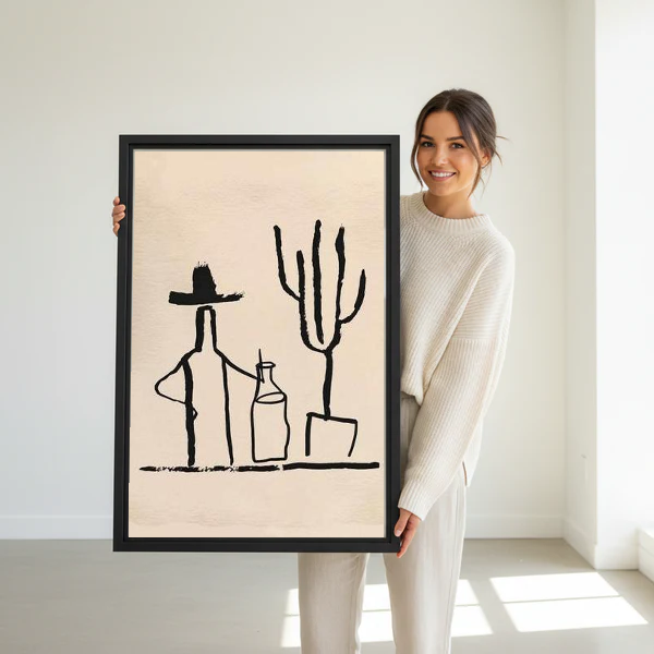 Cowboy Cactus Canvas Wall Art held in a black frame by a standing woman in white.