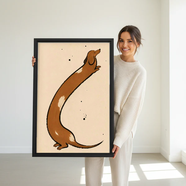 Stretching Dachshund Canvas Wall Art held in a black frame by a standing woman in white.