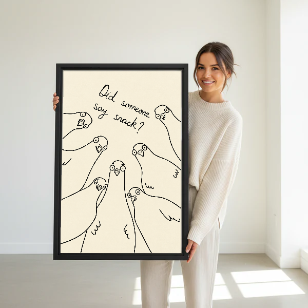 Snack Pigeons Canvas Wall Art held in a black frame by a standing woman in white.