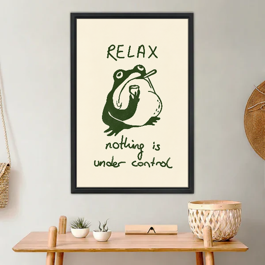 Relax Frog Canvas Wall Art framed above a light wood console with cacti.