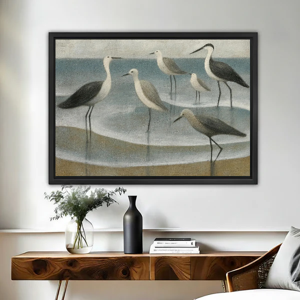 Coastal Gulls Canvas Wall Art framed above a wooden console with black and white vases.