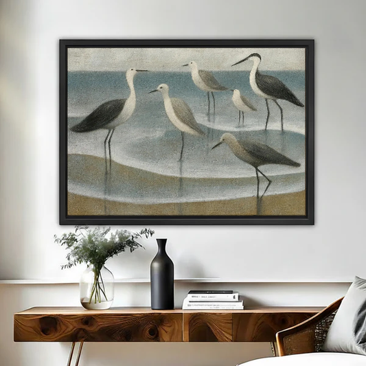 Coastal Gulls Canvas Wall Art framed above a wooden console with black and white vases.
