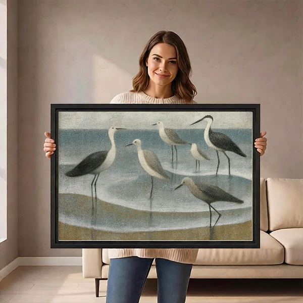 Coastal Gulls Canvas Wall Art held by a standing woman in a neutral room.