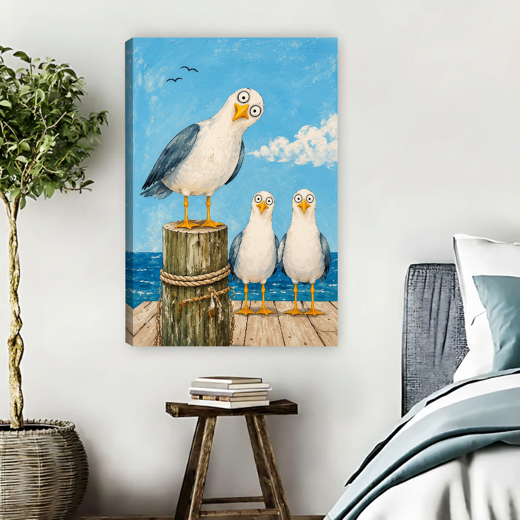 Seagull Trio Canvas Wall Art unframed beside blue bedding and a leafy plant.