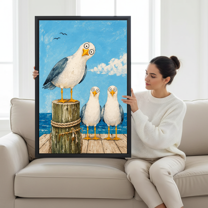 Seagull Trio Canvas Wall Art held by a seated woman on a pale sofa.