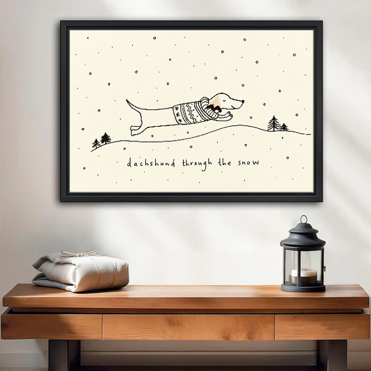 Dachshund Snow Canvas Wall Art framed above a wood console with linen and a lantern.