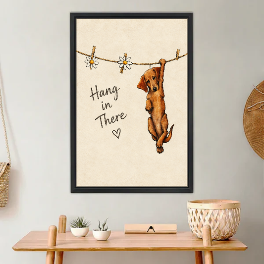 Hang In There Canvas Wall Art framed above a light wood console with cacti.