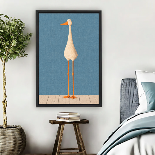 Tall Goose Canvas Wall Art framed beside blue bedding, a leafy plant, and books.