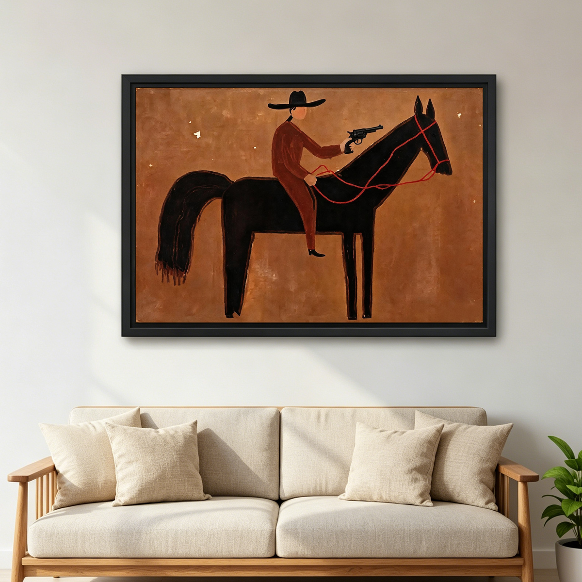 Cowboy Rider Canvas Wall Art framed above a beige sofa with cushions in a bright living room.
