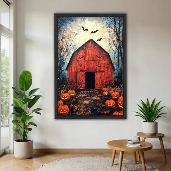 Halloween Barn Canvas Wall Art framed above a wood table with green plants.