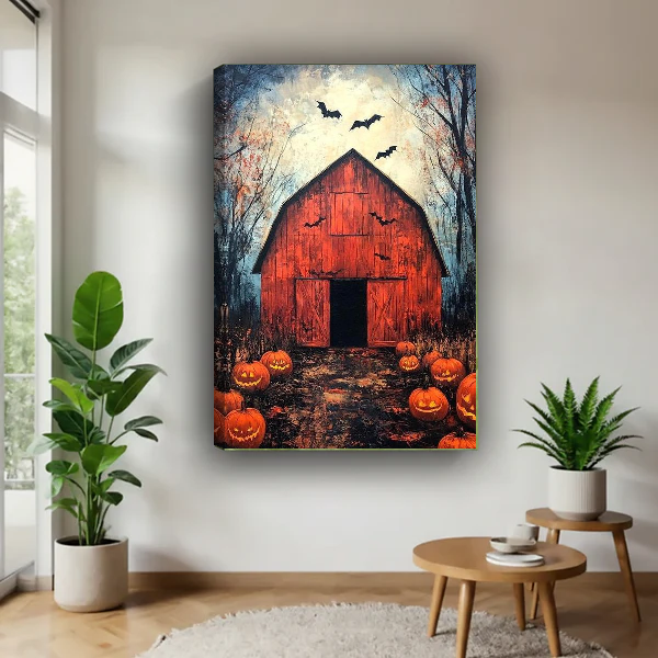 Halloween Barn Canvas Wall Art unframed above a wood table with green plants.