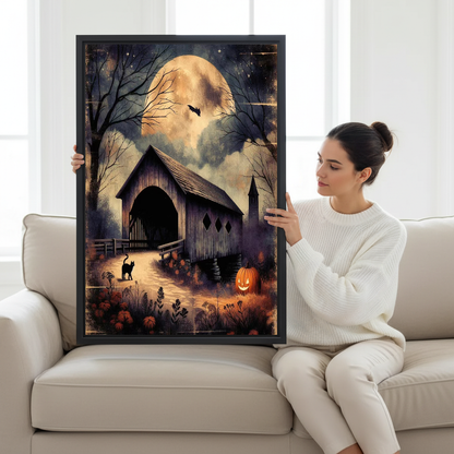 Moonlit Bridge Canvas Wall Art held by a seated woman on a pale sofa.