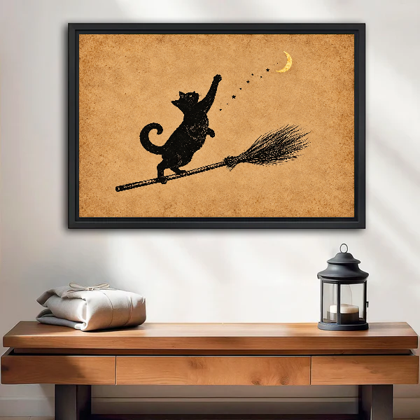 Moon Cat Canvas Wall Art framed above a wood console with linen and a lantern.