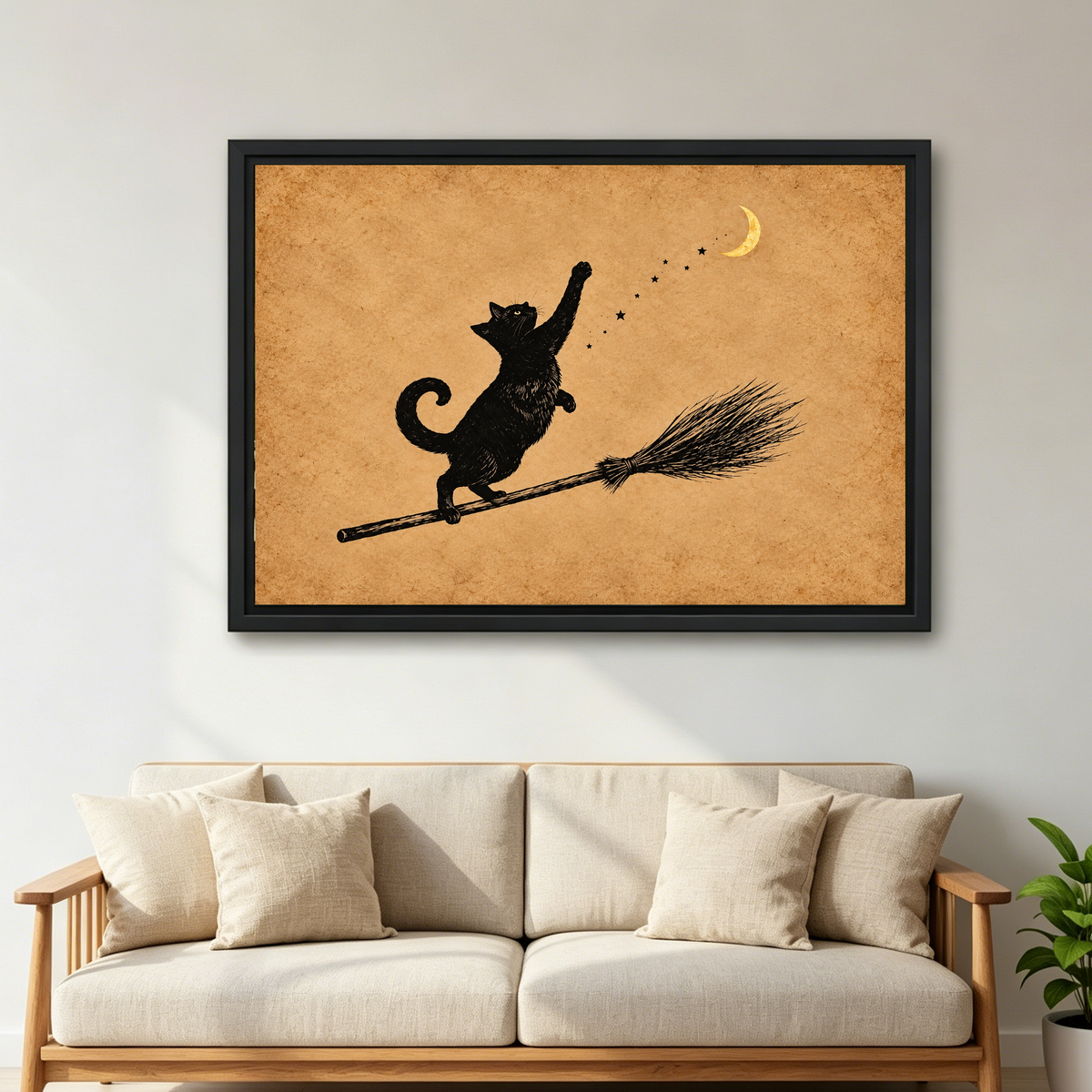 Moon Cat Canvas Wall Art framed above a cream sofa with wooden arms.