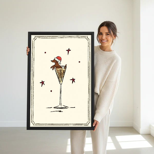 Festive Dachshund Champagne Canvas Wall Art held in a black frame by a standing woman in white.