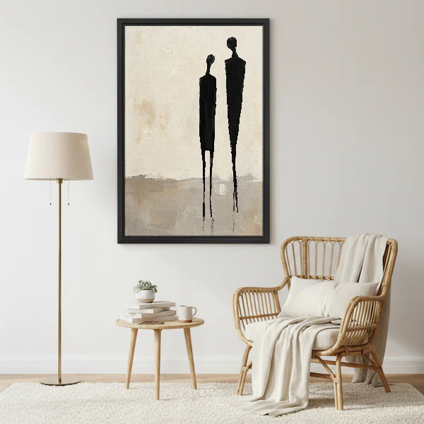 Minimalist Couple Canvas Wall Art framed beside a wicker armchair with floor lamp.