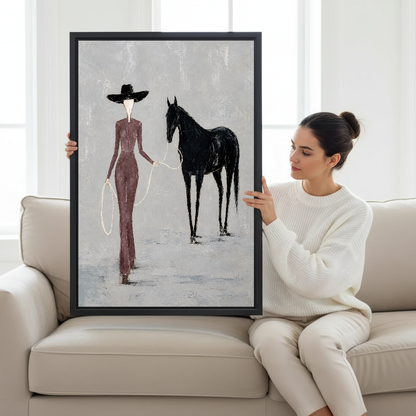 Elegant Woman Horse Canvas Wall Art held in a black frame by a woman seated on a pale sofa.