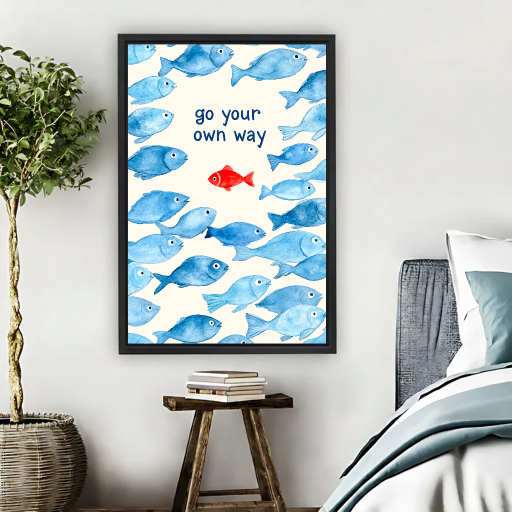 Go Your Way Fish Canvas Wall Art framed beside a blue bed with books and leafy plant.