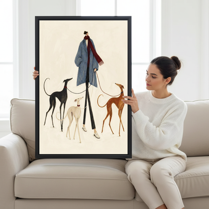 Elegant Woman Hounds Canvas Wall Art held in a black frame by a woman seated on a pale sofa.