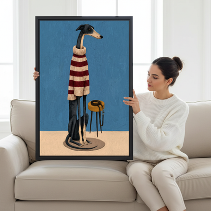Striped Sweater Greyhound Canvas Wall Art held in a black frame by a woman seated on a pale sofa.
