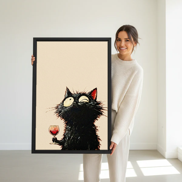 Wide Eyed Wine Cat Canvas Wall Art held in a black frame by a standing woman in white.