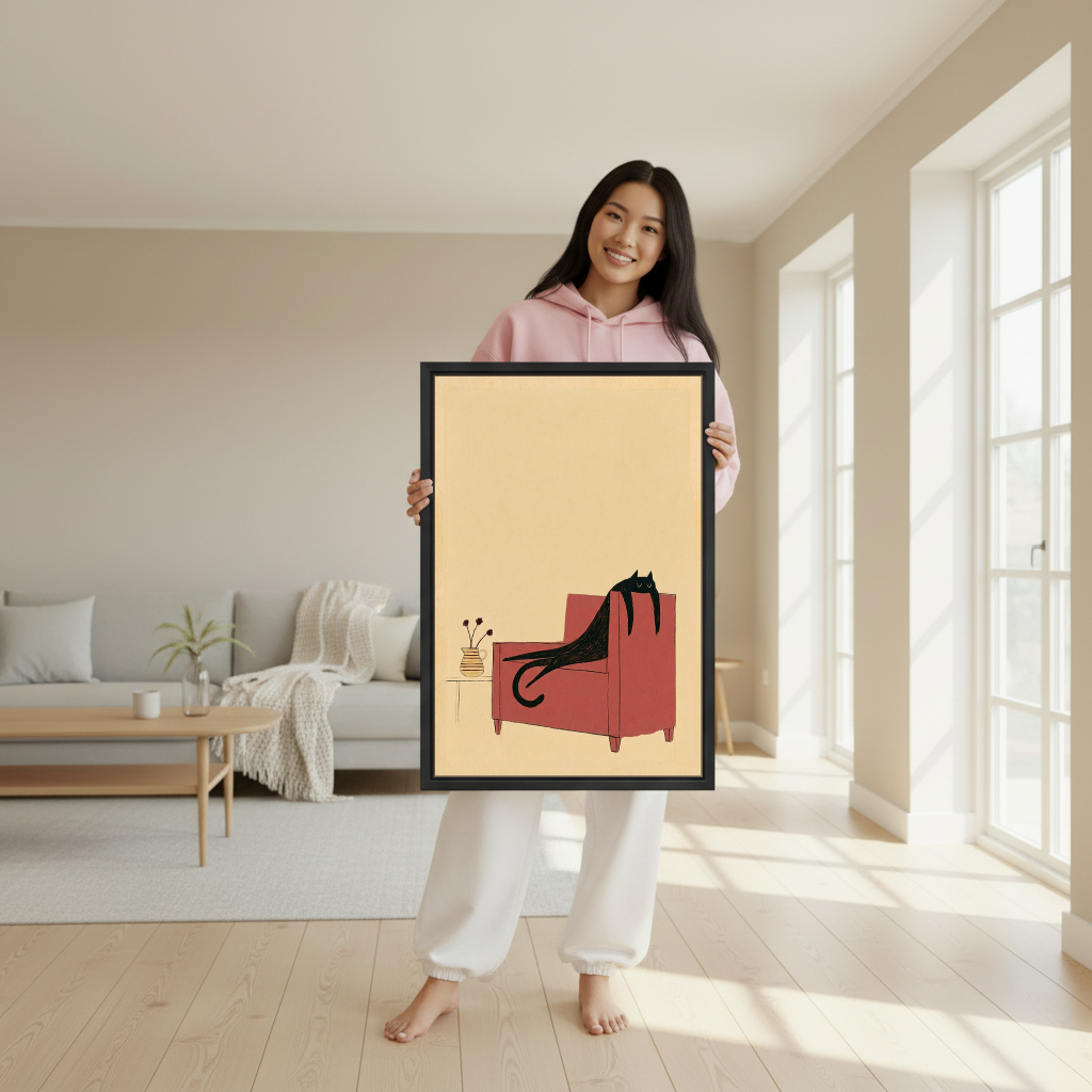 Lounging Chair Cat Canvas Wall Art held in a black frame by a woman wearing pink.