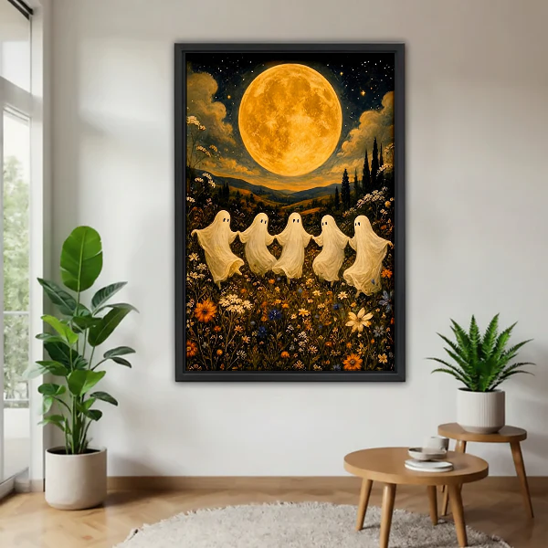 Moonlit Dancing Ghosts Canvas Wall Art framed above a warm wood table with leafy plants.