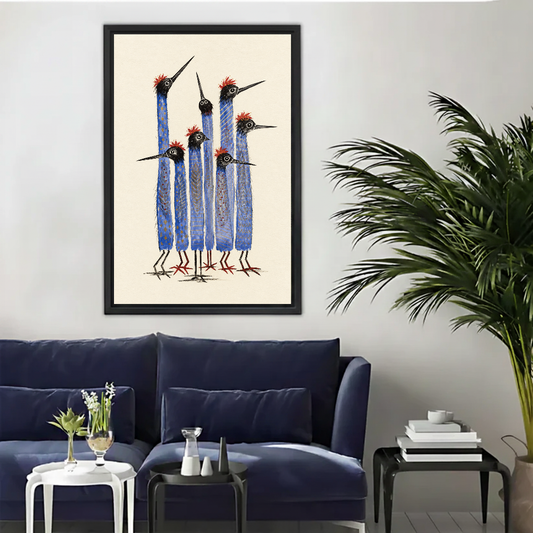 Tall Blue Birds Canvas Wall Art framed above a navy sofa with palm and side tables.