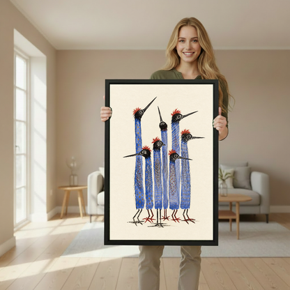 Tall Blue Birds Canvas Wall Art held in a black portrait frame by a standing woman.