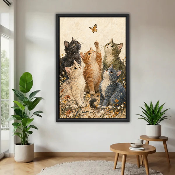 Butterfly Kittens Canvas Wall Art framed above a wood table with green plants.
